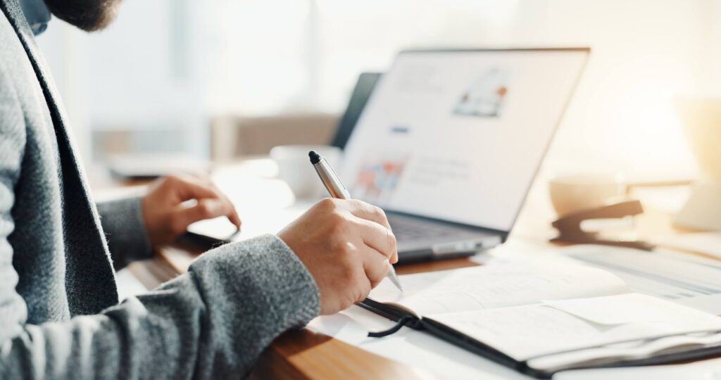 Man with a pen at a laptop giving feedback